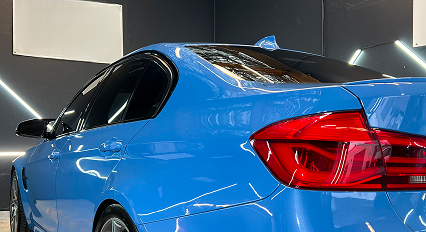 blue BMW in the garage at Raw Coatings & Detailing